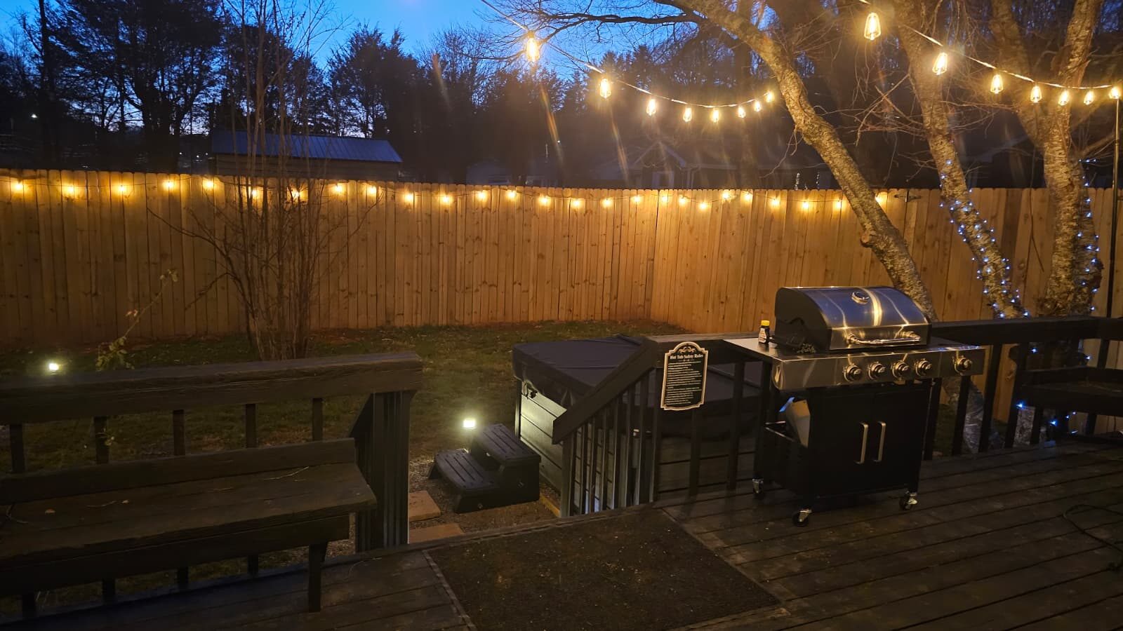 Hot tub lit up at night with mountain breezes